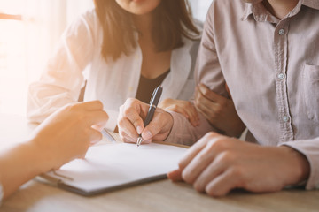 Salesmen are letting the male customers sign the sales contract, Asian women and couple are doing business in the office, Business concept and contract signing