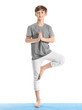 © Pixel-Shot - Cute little boy practicing yoga on white background
