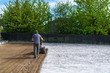 © Martin - man plows the ground with a motor cultivator. A farmer ploughs the soil using a petrol cultivator.