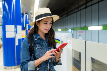 Sticker - Woman use of mobile phone on train platform