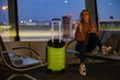© Андрей Котомин - Sexy blonde at the airport with a boarding pass and a suitcase