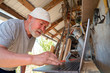© andrey - Elderly man communicates with a laptop in village
