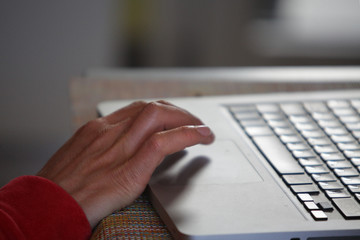 Hands working on the computer keyboard