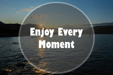 Wall Mural - Inspirational quote on a natural landscape background. Enjoy Every Moment.