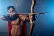 © serhiibobyk - Muscular mature spartan shooting from bow.