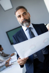 Wall Mural - Confident senior businessman leader working in office