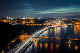 Fototapeta Most - night cityscape. aerial view. colorful led bridge across river and quay road in Kyiv