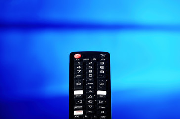 TV remote control pointing towards the television screen