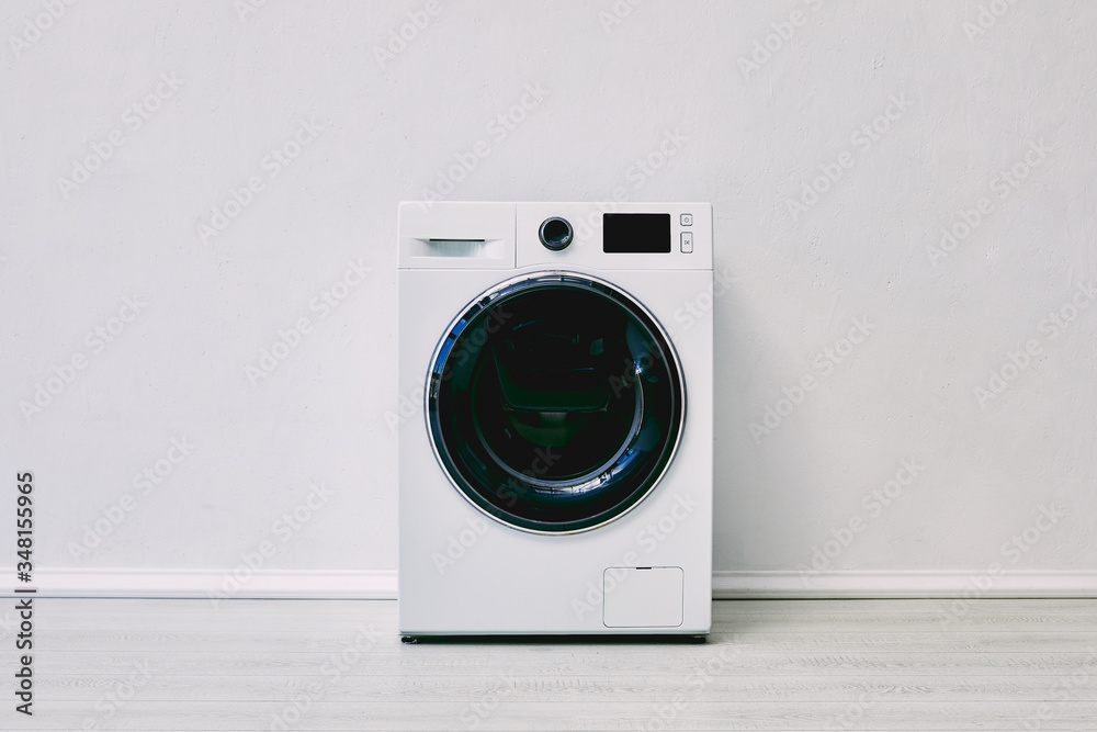 modern washing machine near white wall in bathroom - obrazy, fototapety, plakaty 