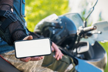 Motor Biker Is Showing In Hands A Blank Screen Mobile Phone. Online Navigator.