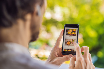 man orders food for lunch online using smartphone