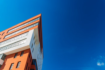 Wall Mural - new modern architecture triangle exterior building red and white walls color foreshortening from below on vivid blue sky background space for copy or your text poster concept format