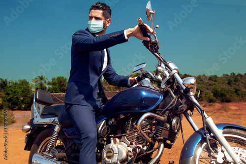 Cuadros en Lienzo Man in face mask on motorcycle in suite