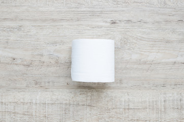 white toilet paper roll on wood background.