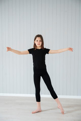 a teenage girl plays sports at home during quarantine in a bright room