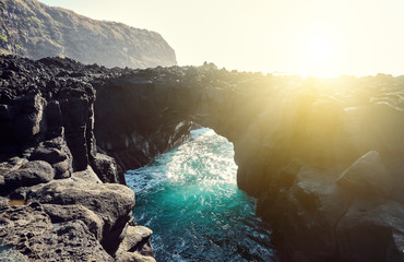 Wall Mural - San Miguel Island, Azores, Portugal.  Natural arch made of black stone.