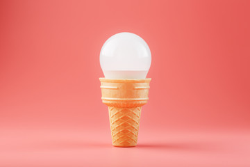 Light bulb ice cream in a waffle Cup on a pink background.