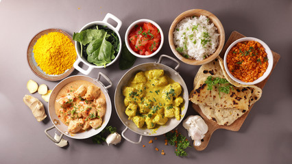 Wall Mural - indian food meal in bowl with curry, chicken, naan and rice