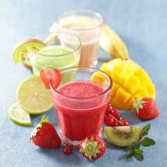 Poster - smoothie with fresh fruits on blue background