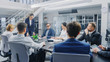 © Gorodenkoff - Corporate Meeting Room: Young and Ambitious Female Executive Director Delivers Powerful Speech About Company’s Achievement of Record-Breaking Annual Revenue Results to a Board of Executives, Investors