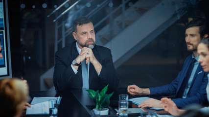 Wall Mural - Corporate Meeting Room: Charismatic Director Decisively Leans on a Conference Table and Delivers Report to a Board of Executives about Company’s Record Breaking Revenue