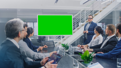 Wall Mural - In the Corporate Meeting Room: Creative Director Uses Digital Chroma Key Interactive Whiteboard for Presentation to a Board of Executives, Lawyers, Investors. Green Mock-up Screen in Horizontal Mode