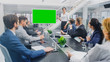 © Gorodenkoff - In the Corporate Meeting Room: Female Speaker Uses Digital Chroma Key Interactive Whiteboard for Presentation to a Board of Executives, Lawyers, Investors. Green Mock-up Screen in Horizontal Mode