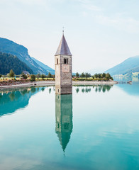 Fototapete - The old bell tower of Curon Venosta church rising out of the waters lake of Resia.