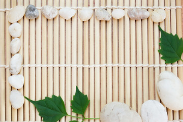 Bamboo background with leaves and stone as the frame