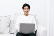© Gengwit - Attractive asian male working with computer laptop at home. Analyzing online data to success business