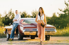 Love Story Woman And Man With Buick Riviera Retro Style. Unique Car.