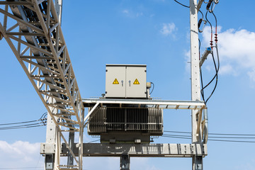 High voltage electrical transformer on concrete pole.