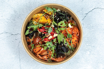 Wall Mural - Hawaiian salmon fish poke bowl with rice, radish,cucumber, tomato, sesame seeds and seaweeds. Buddha bowl. Diet food