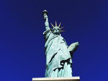 Statue Of Liberty Against Blue Sky On Sunny Day