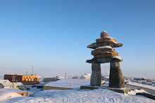 Single Inuksuk Or Inukshuk Landmark Covered In Snow On The Top Of The Hill In The Community Of Rankin Inlet, Nunavut, Canada