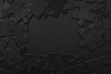 Black Puzzles On A Black Background, Conceptual Photo With Place For Your Text