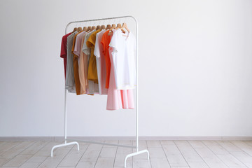 Wall Mural - fashion clothes on a stand in a light background indoors. place for text
