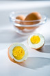 Cut in half and whole boiled eggs on the white background