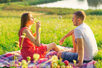 beautiful young man and woman at a picnic. couple in love by the