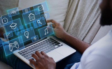 Internet life. African American guy with laptop at home, creative collage with various functional pictograms