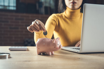 woman hand coins and piggy bank with computer