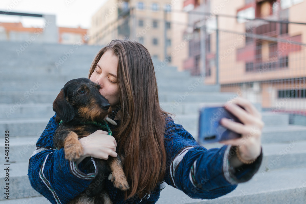 Beautiful Young adult woman taking a selfie photo kissing her dog Stock ...