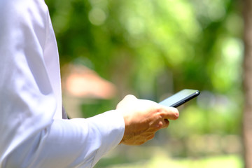 Poster - close up businessman using a smartphone and space for text