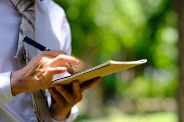 Poster - businessman writing on a notebook and successful planning