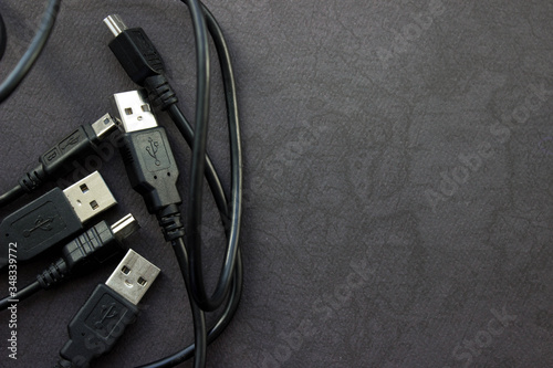 Fotografía Close up USB and mini USB cables on black background with place for your design