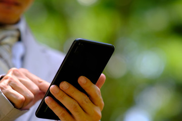 Poster - businessman using a smartphone and space for text
