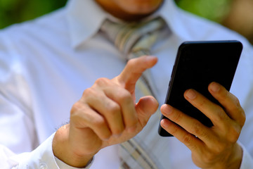 Poster - close up businessman using a smartphone and space for text
