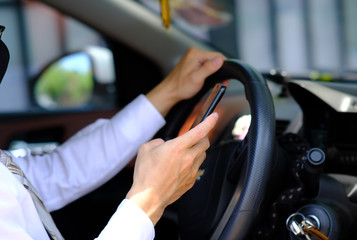 businessman using his phone while traveling drive in a car