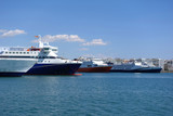 Fototapeta Krajobraz - Photo of anchored passenger ferries in busy port of Piraeus on a spring morning, Attica, Greece