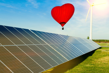 Wall Mural - hot air balloon red heart over solar panel - ecological energy dream